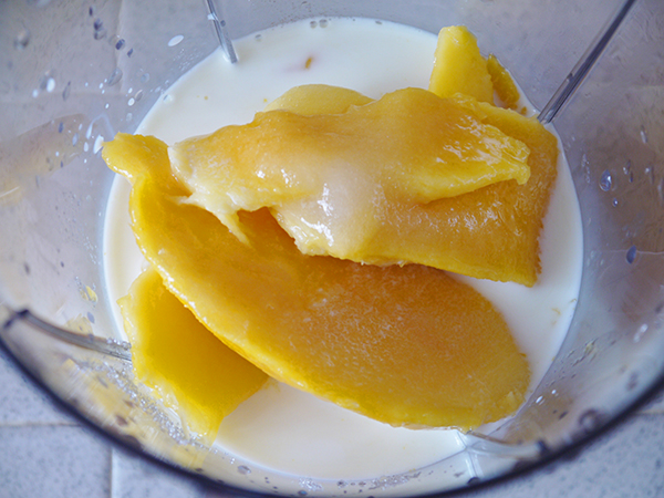 blend the mango flesh, milk and sugar in a blender