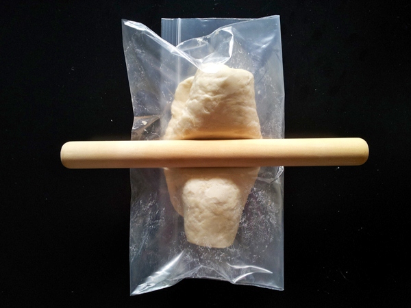fold up the bag in the middle and knead the dough with a rolling pin until the bag is filled