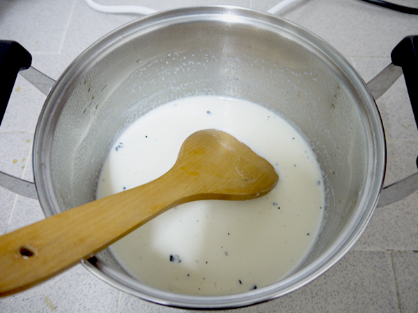 heat milk and vanilla (both skin and seeds) in a pot, stirring often until it begins to boil, remove the pot from heat, set aside