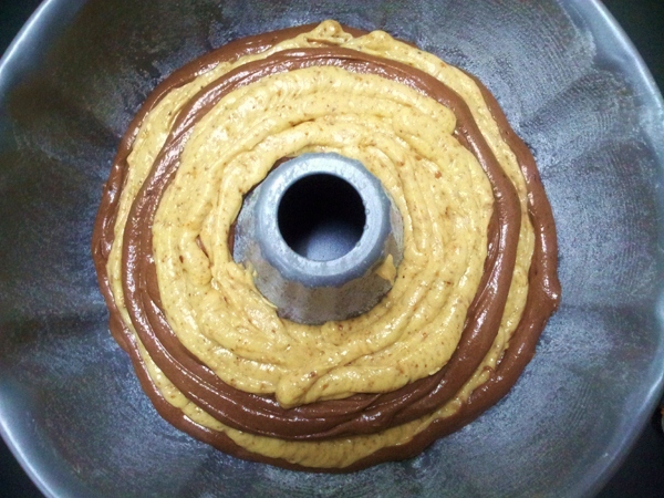pipe the mixtures alternately in circular movement into the Bundt pan