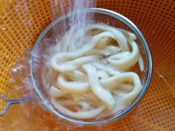 strain and rinse the Udon noodles with running water