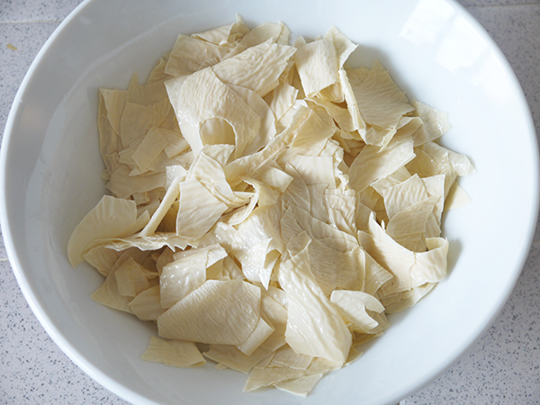 tear tofu skin into small pieces and drain well